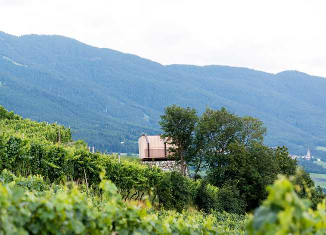 Mountain landscape with wooden architecture at its centre