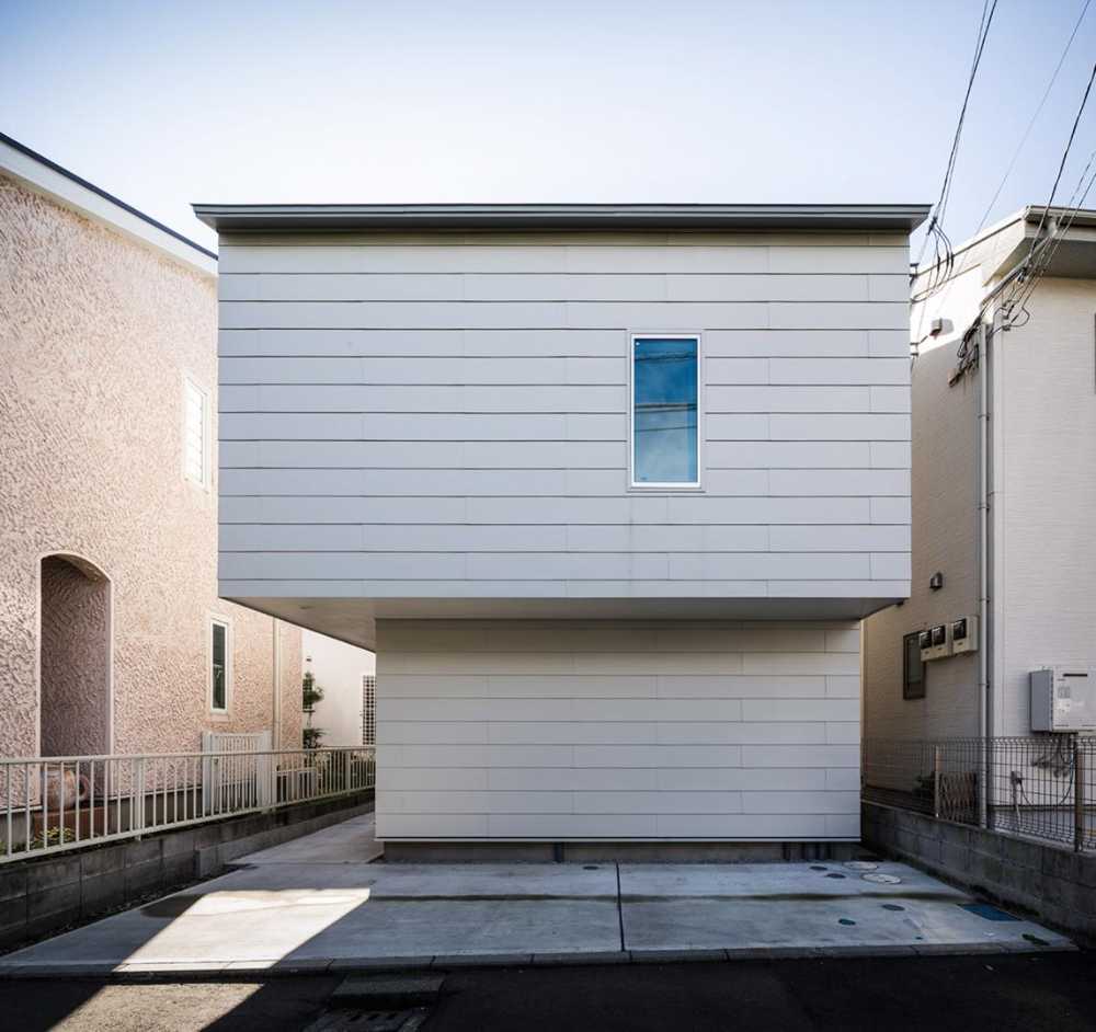 Cantilevered wooden house with horizontal slats