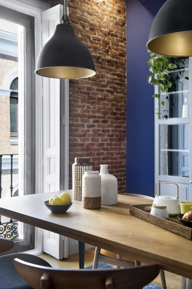 Brick and blue dining table and wall