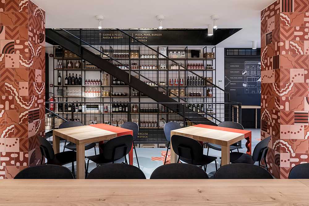 Restaurant with colored columns and internal wooden staircase