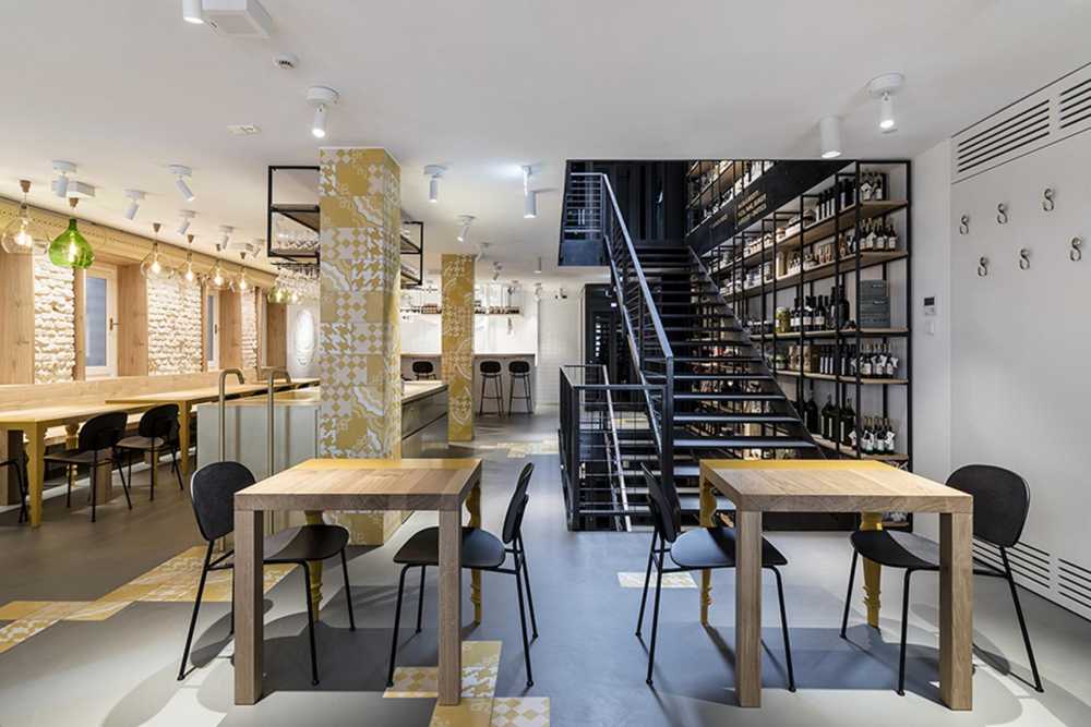 Restaurant with colored columns and internal wooden staircase
