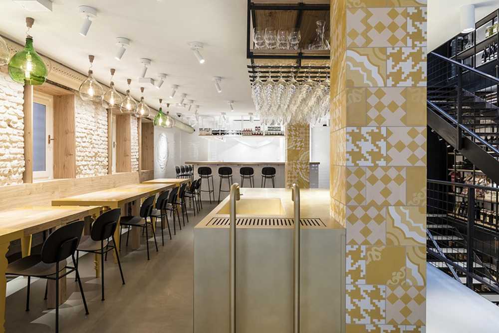 Restaurant with colored columns and internal wooden staircase