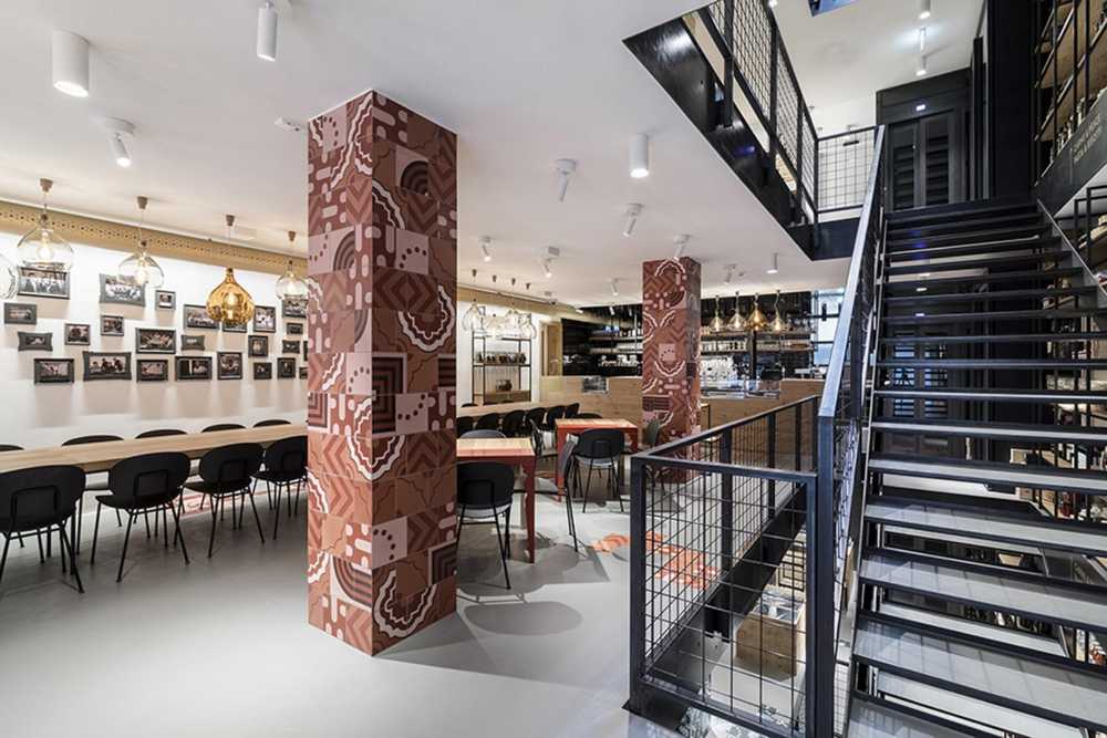 Restaurant with colored columns and internal wooden staircase