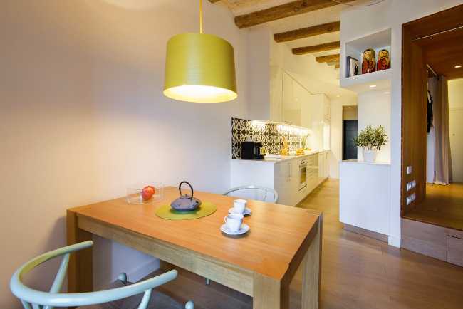 White kitchen and wooden dining table
