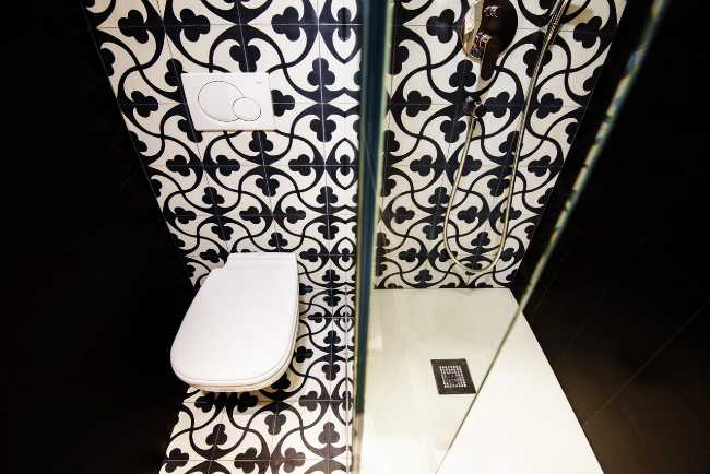 White and black bathroom with glazed shower cubicle