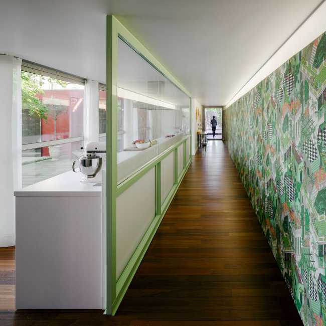 Corridor with stained glass window and colored wall