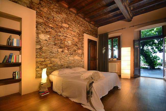 camera da letto con parete in pietra