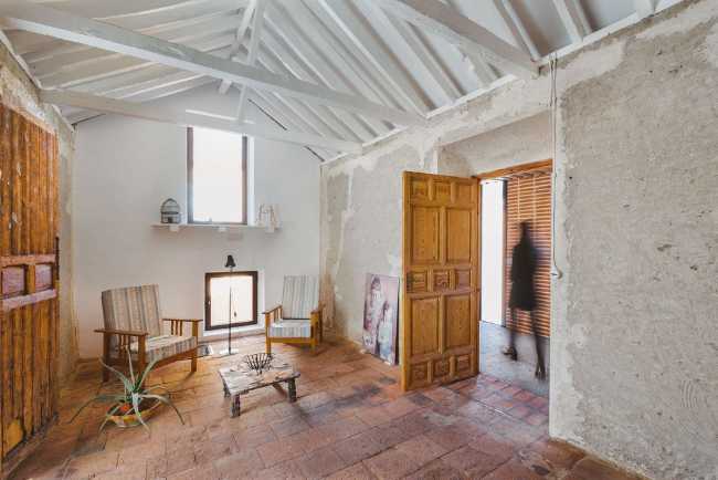 Inside agricultural building with white painted wooden roof