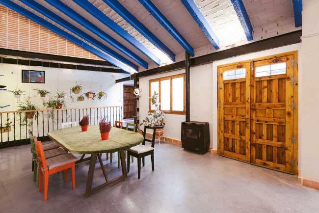 Inside agricultural building with attic and blue beams