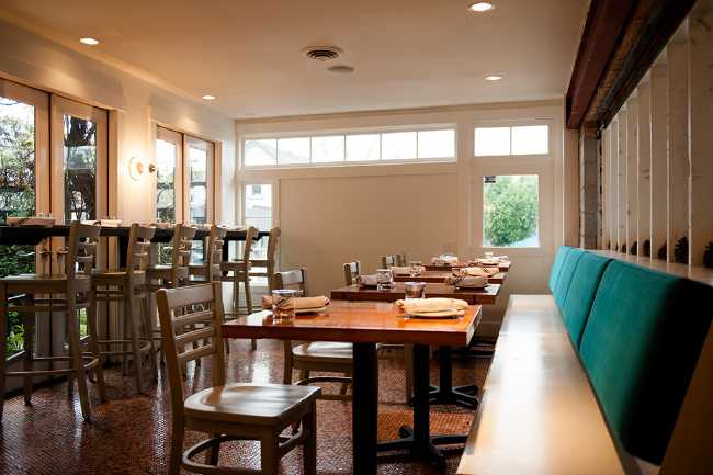 Interior restaurant in white wood and colored sofas