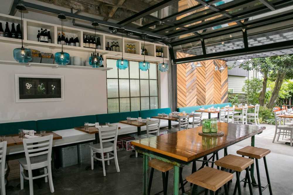 Interior restaurant in white wood and colored sofas