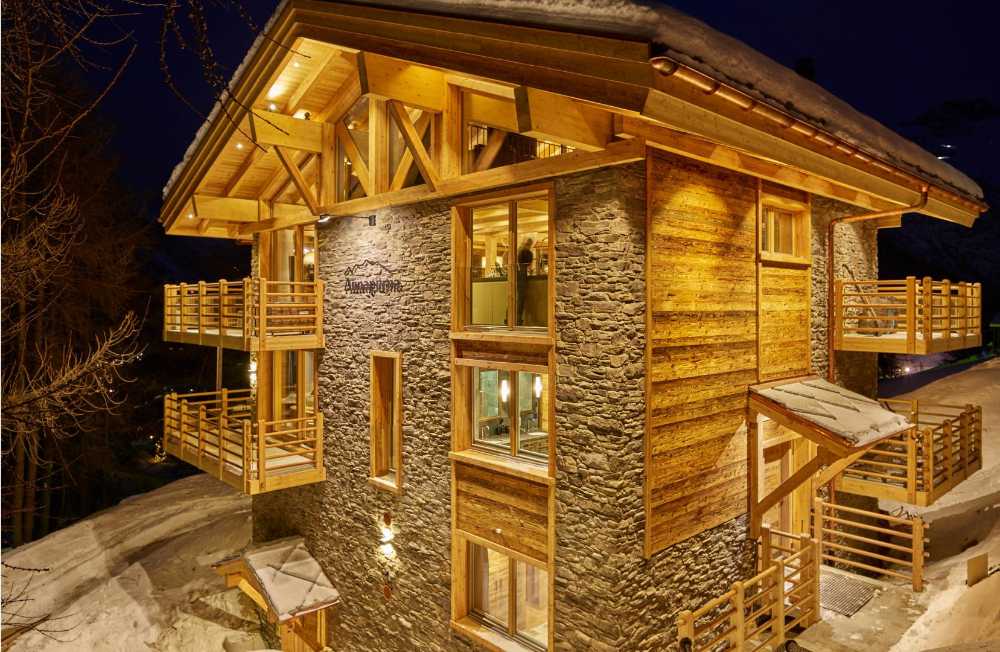 Resort with antique wooden structure and stone cladding