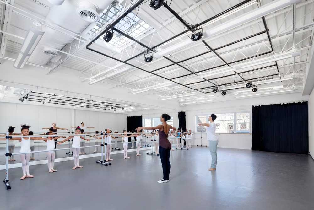 dance school with white interiors and grey and yellow sofas