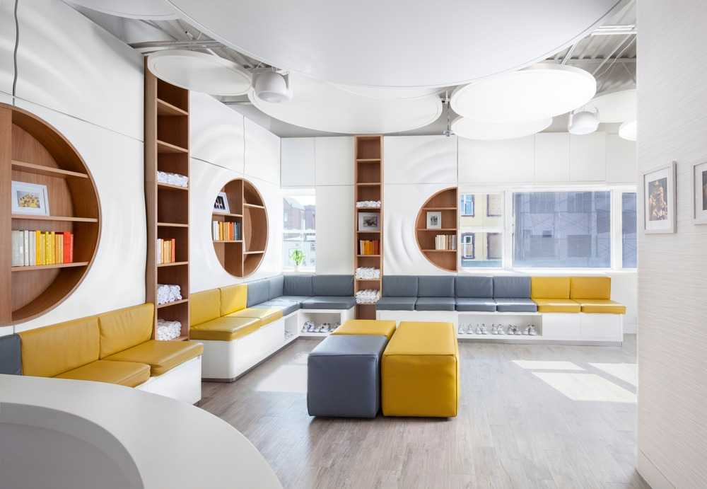 dance school with white interiors and grey and yellow sofas