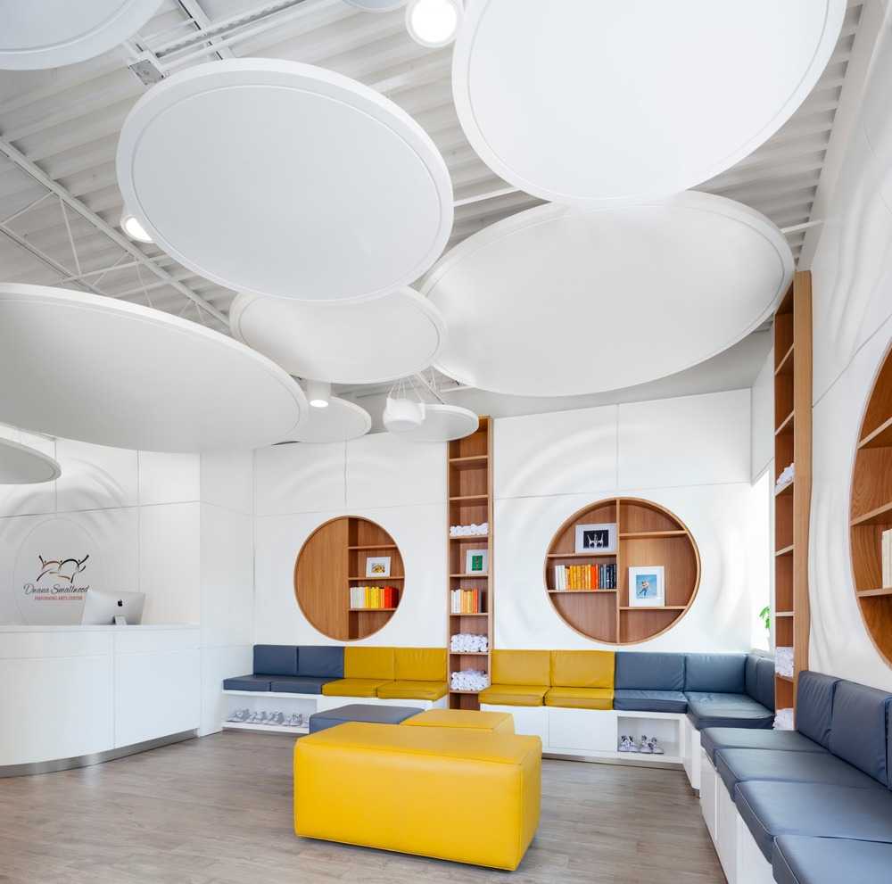 dance school with white interiors and grey and yellow sofas