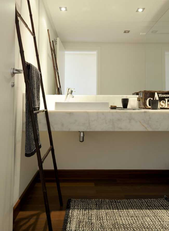 Bathroom with white walls, wooden floor and marble floor