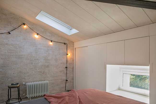 Bedroom of an attic with hanging lights