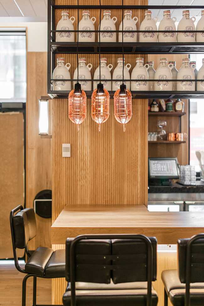 concept store restaurant finishes and wooden counter seats high in black leather