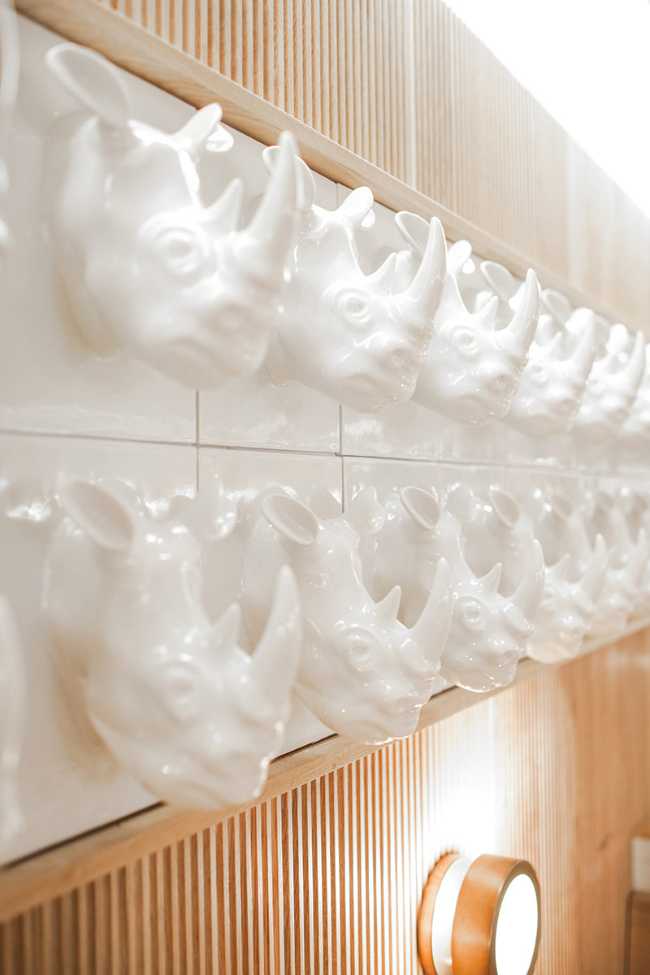 concept store restaurant detail white unicorns on the wall