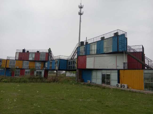 overlapping containers, covers and external wooden cladding