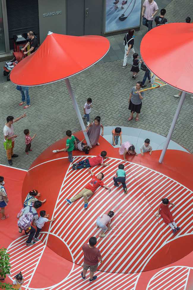 Public space with red umbrellas