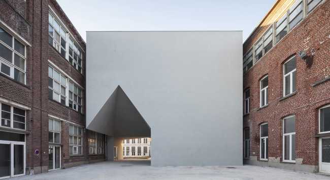 White volume between two historic buildings