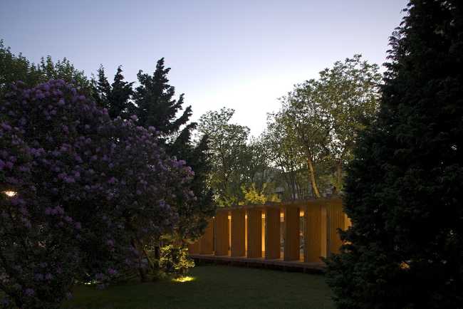 Wooden pavilion in a garden at night