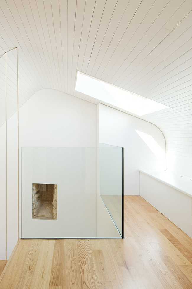 White attic with wooden floor