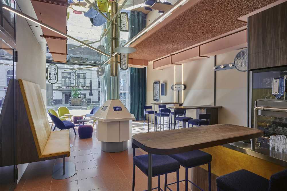 CityHub Hotel wooden tables and colored chairs