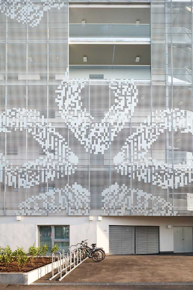 Residential complex facade perforated sheet metal corridor connections