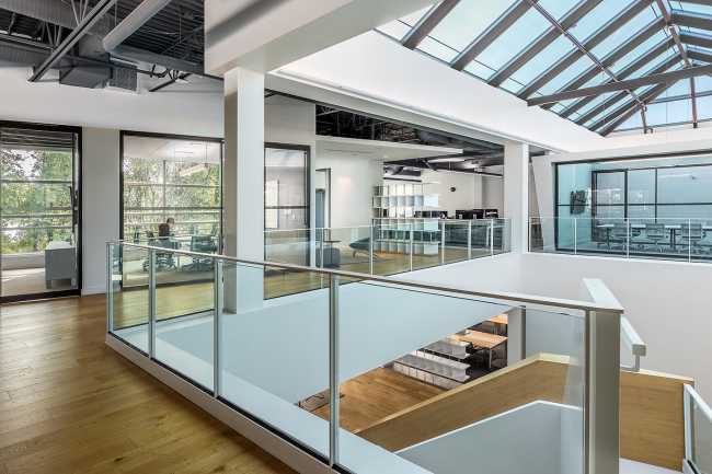 offices double volume wooden floors skylight
