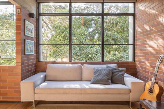 Large window with sofa and guitar