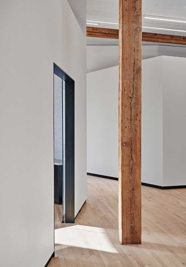 Attic with white walls and wooden column