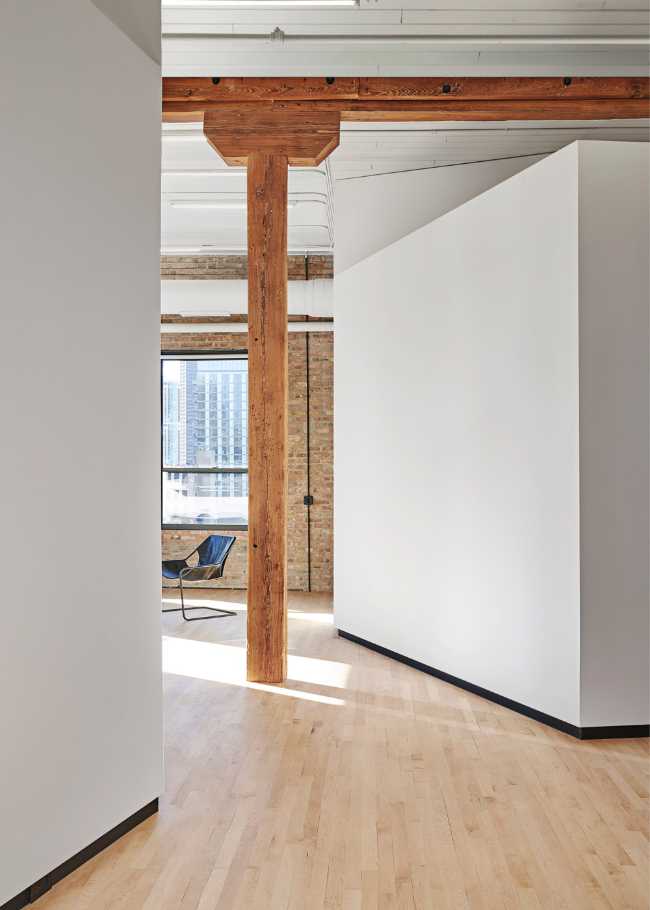 Attic with white walls and wooden column
