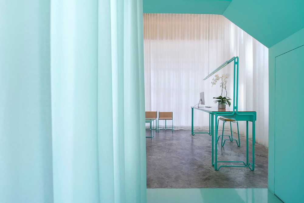Spa inside a Shophouse in Bangkok. Colours, light and fabrics for the double volume