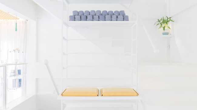 Spa inside a Shophouse in Bangkok. Colours, light and fabrics for the double volume