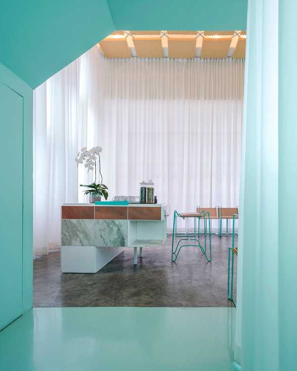 Spa inside a Shophouse in Bangkok. Colours, light and fabrics for the double volume