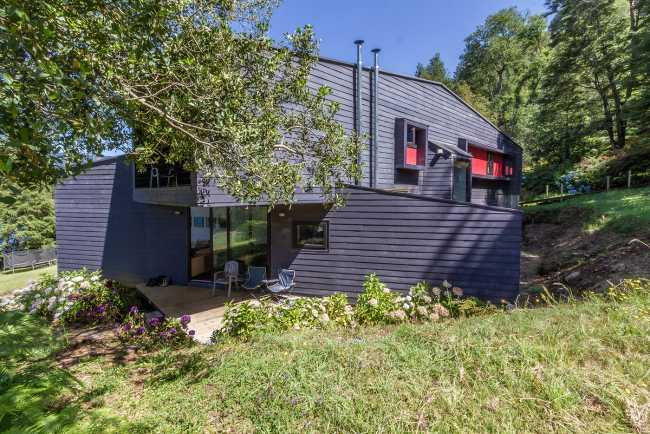 Dark wooden houses in the green