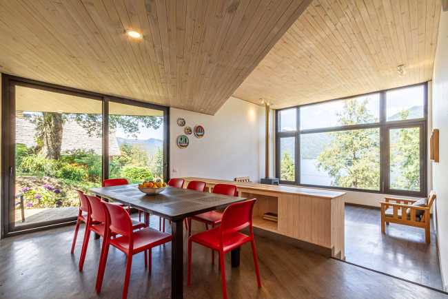 Wooden interior of a house with red chairs