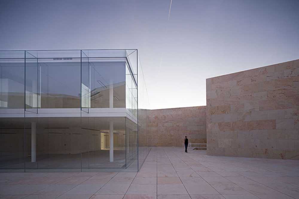 office building glass facade continuous stone flooring