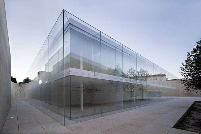 office building glass facade continuous stone flooring