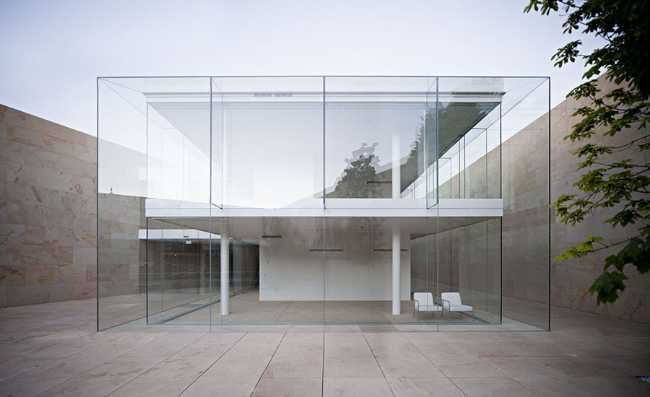 office building glass facade continuous stone flooring