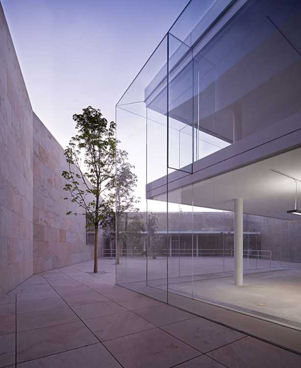 office building glass facade continuous stone flooring