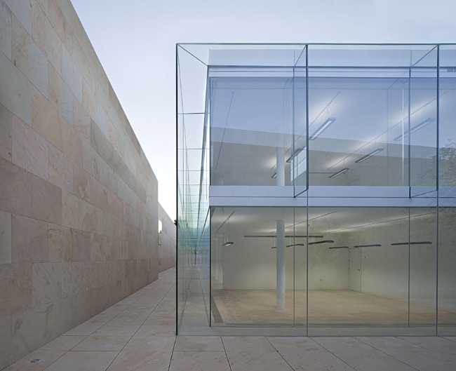 office building glass facade continuous stone flooring