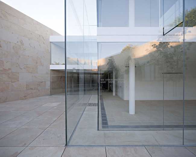 office building glass facade continuous stone flooring