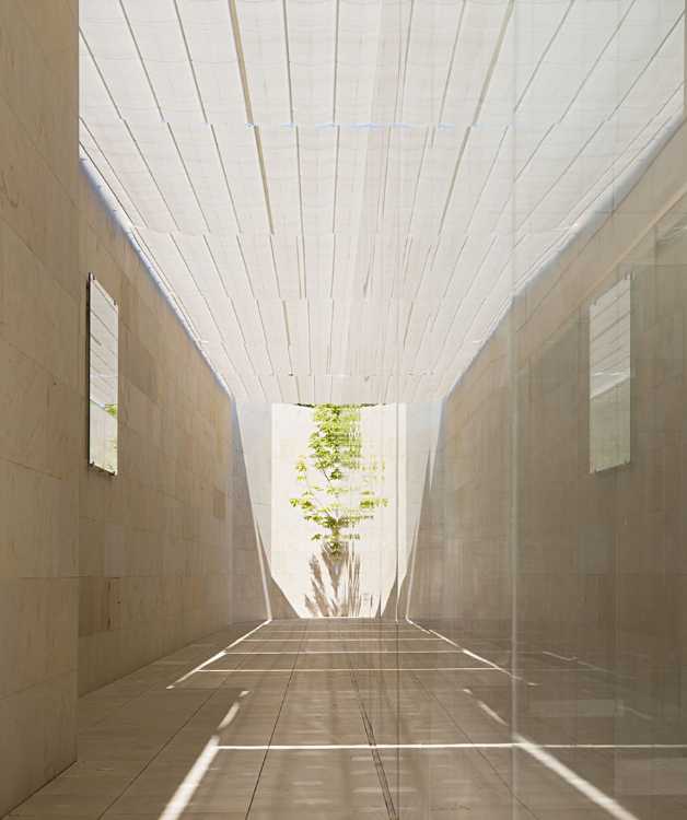 office building glass facade continuous stone flooring