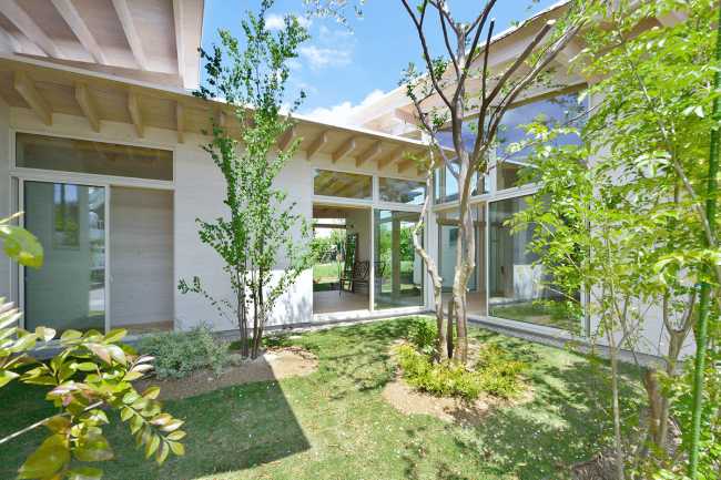 Wooden house with green space in the center