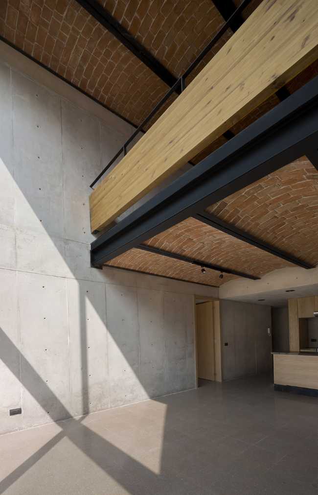 housing unit double volume structure reinforced concrete vaults exposed brick wood