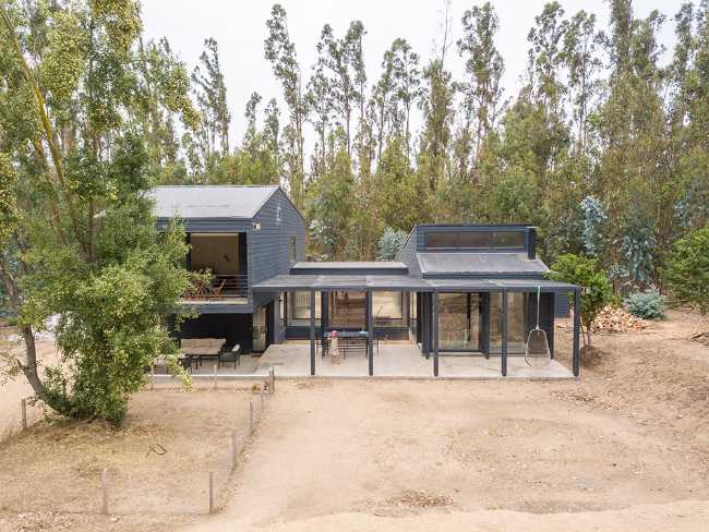 Wooden house among the trees with swimming pool