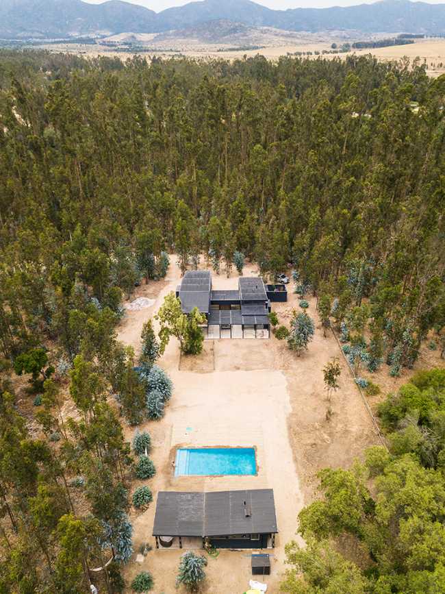 Wooden house among the trees with swimming pool